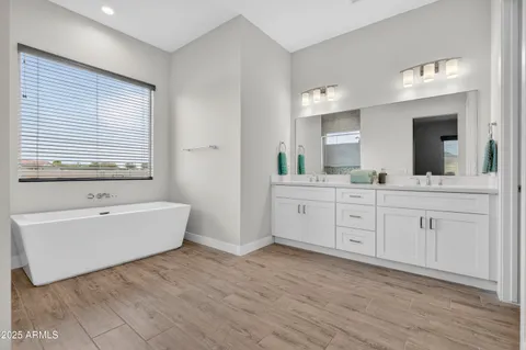 a bathroom with a double vanity sink and a mirror
