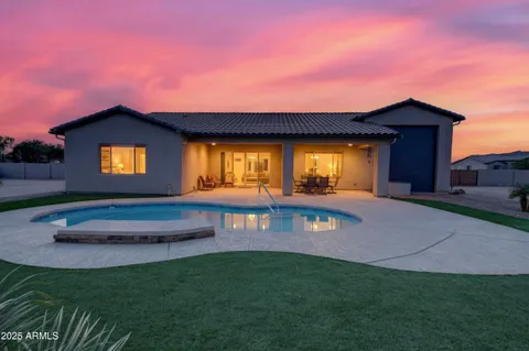 a view of a swimming pool with outdoor seating