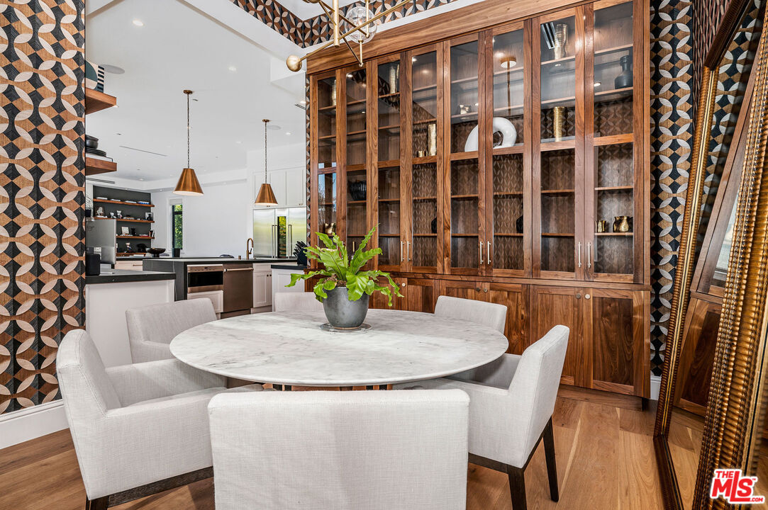 4421 Haskell Avenue Encino, CA 91436 - Photo 12 of 32 a dining room with furniture and wooden floor