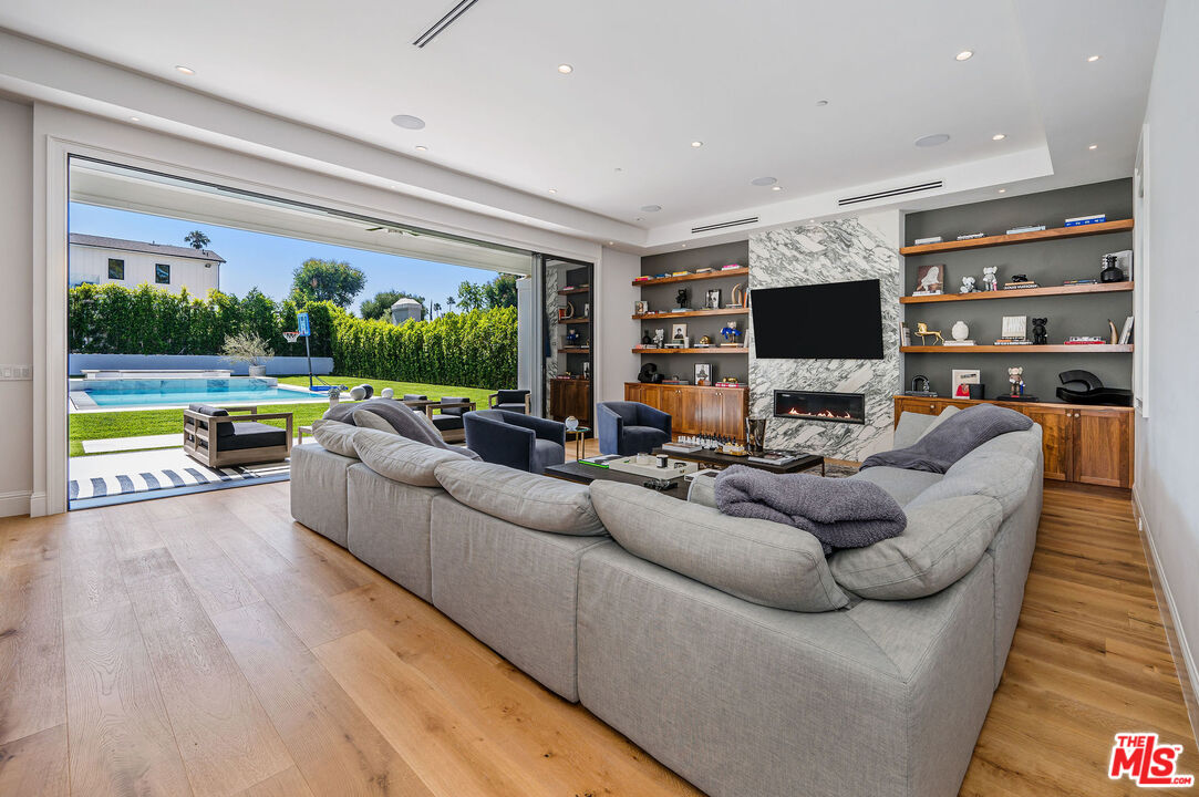 4421 Haskell Avenue Encino, CA 91436 - Photo 13 of 32 a living room with furniture and a flat screen tv