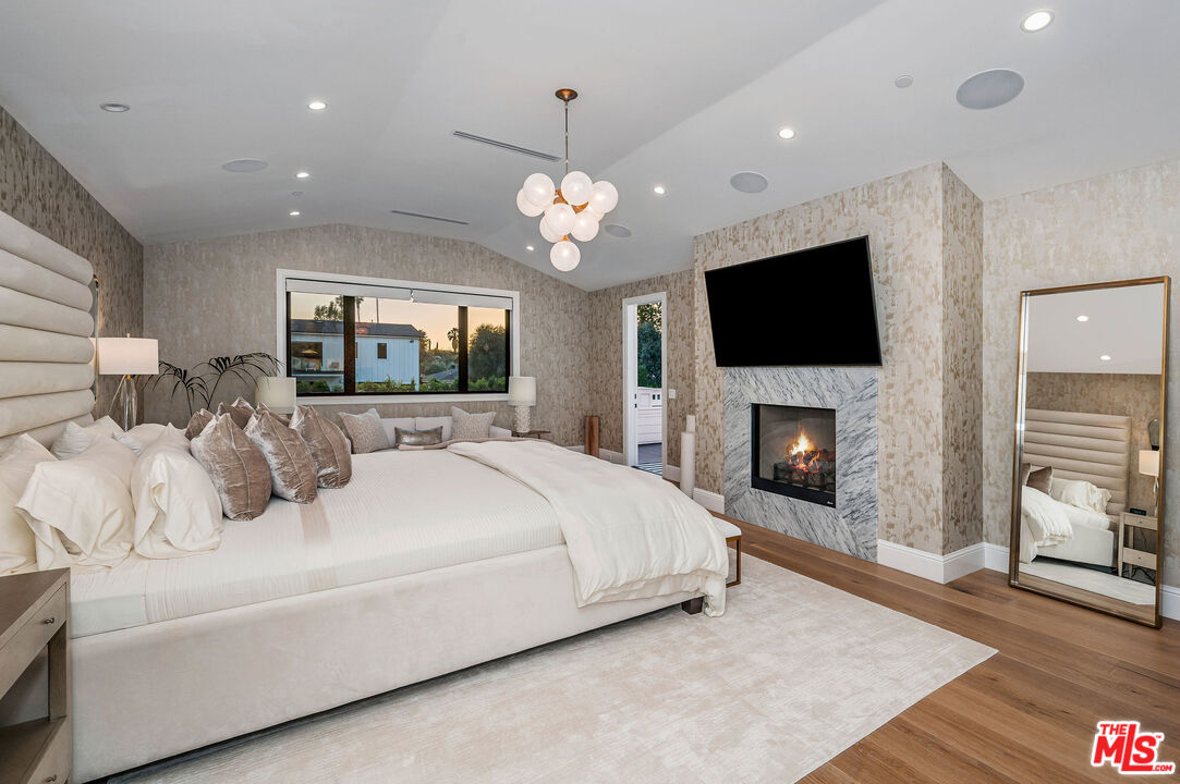 4421 Haskell Avenue Encino, CA 91436 - Photo 17 of 32 a large bedroom with a bed and a flat screen tv