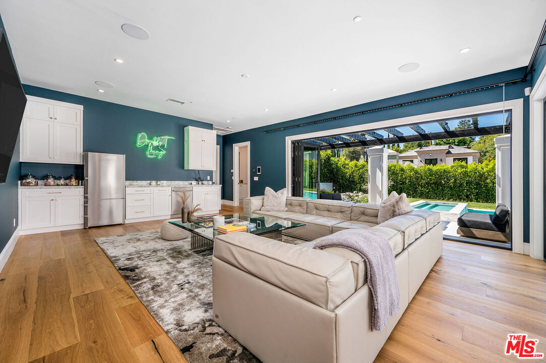 4421 Haskell Avenue Encino, CA 91436 - Photo 27 of 32 a living room with furniture large window and a table