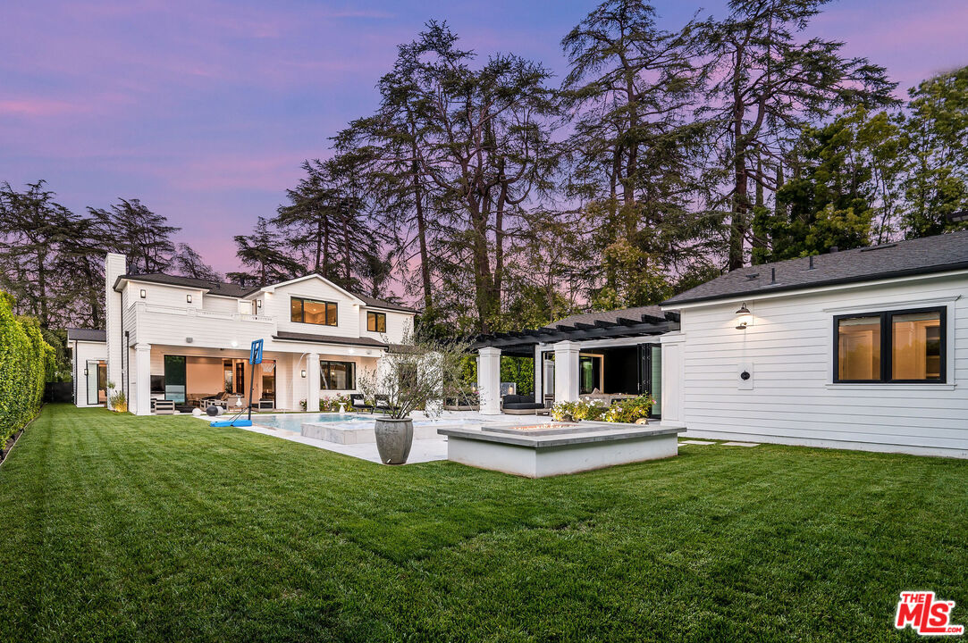 4421 Haskell Avenue Encino, CA 91436 - Photo 30 of 32 a front view of a house with a garden and trees