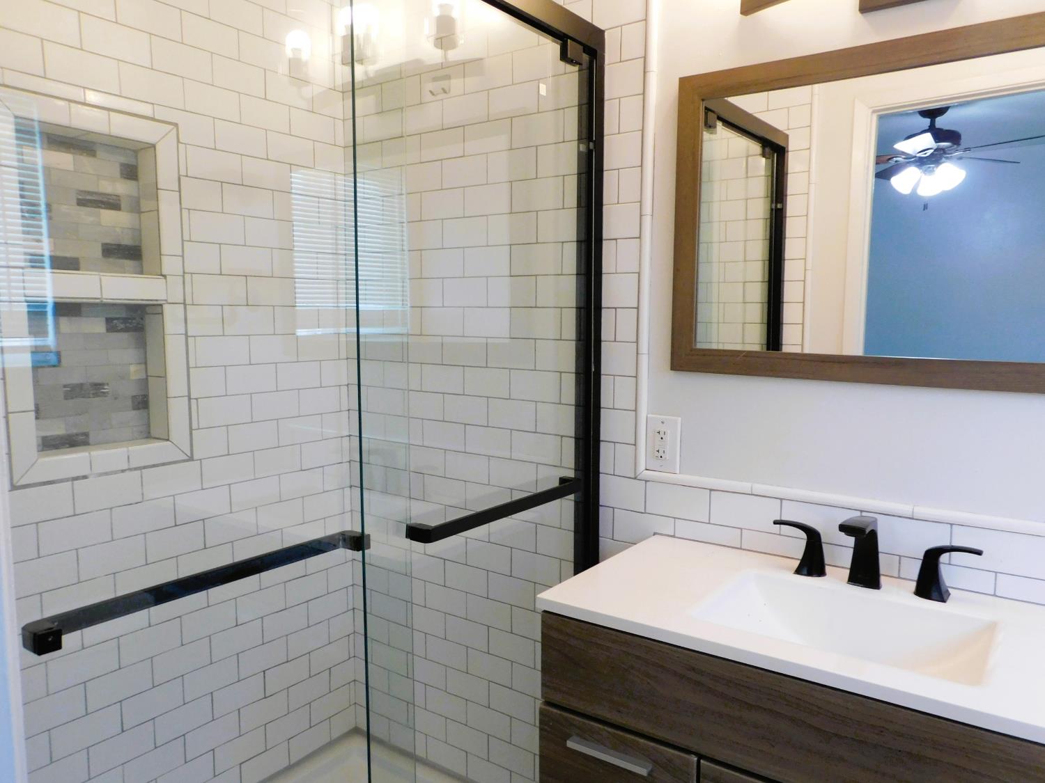 51 West Richert Avenue Clovis, CA 93612 - Photo 11 of 13 a bathroom with a sink and a mirror