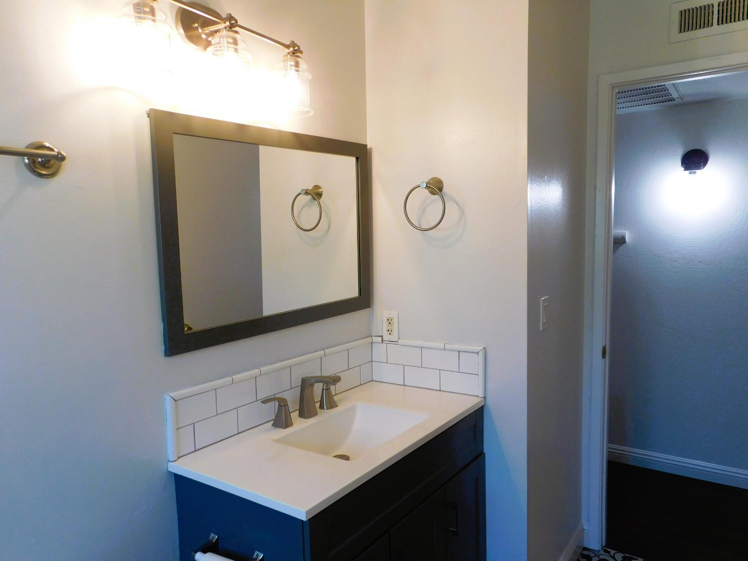 51 West Richert Avenue Clovis, CA 93612 - Photo 6 of 13 a bathroom with a sink and mirror