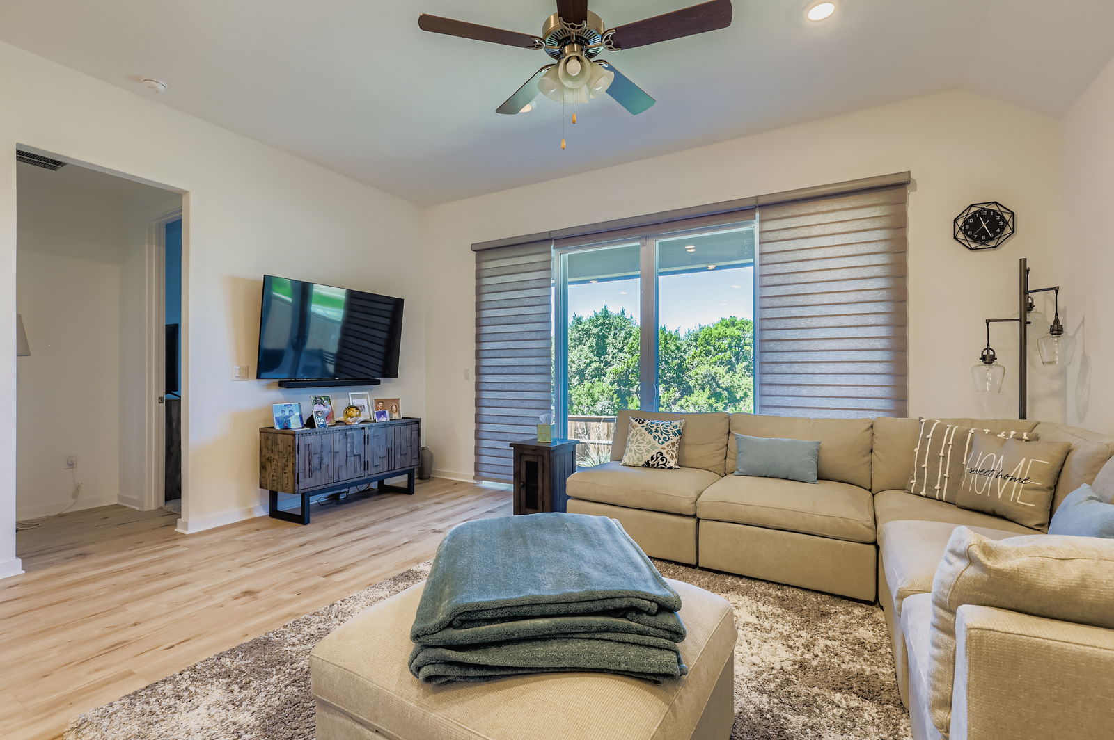 1909 Ruger Pass Leander, TX 78641 - Photo 4 of 31 Living room featuring light wood-style floors, a ceiling fan, vaulted ceiling, and recessed lighting