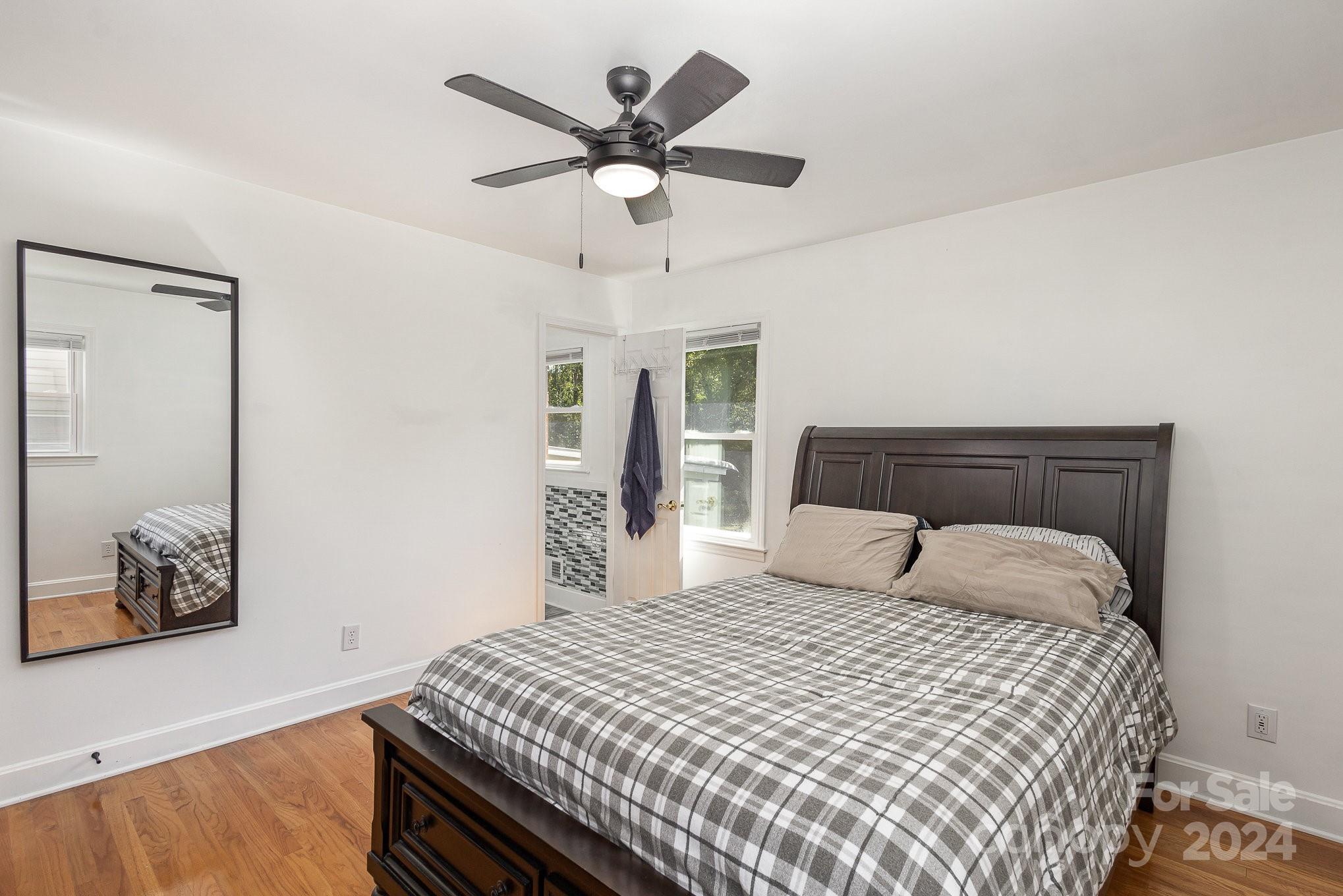 4431 Westridge Drive Charlotte, NC 28208 - Photo 13 of 24 a bedroom with a large bed and a chandelier