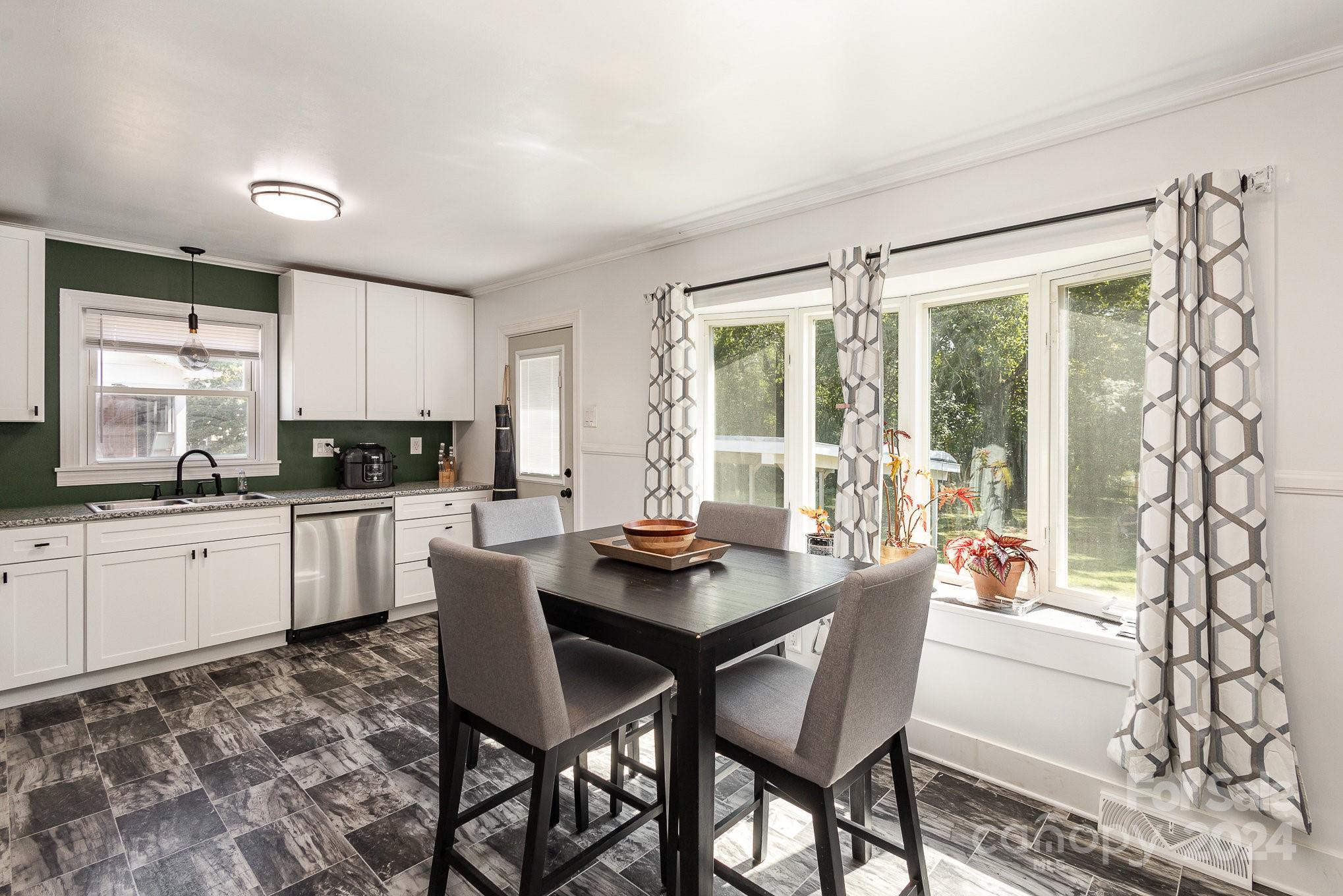 4431 Westridge Drive Charlotte, NC 28208 - Photo 6 of 24 a kitchen with a table chairs stove and cabinets