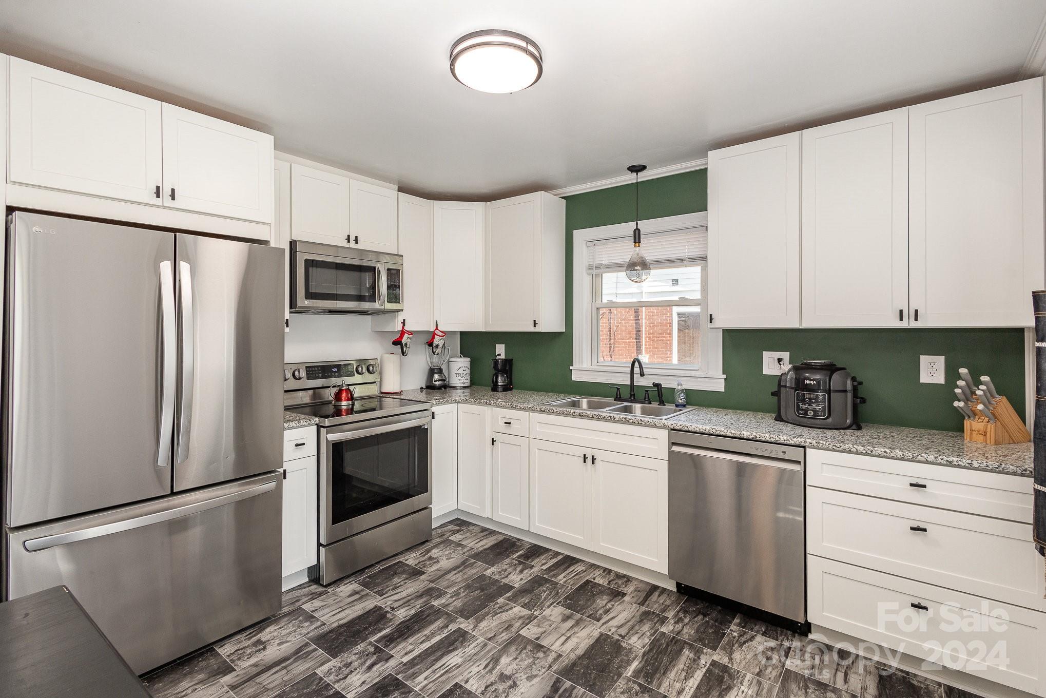 4431 Westridge Drive Charlotte, NC 28208 - Photo 10 of 24 a kitchen with cabinets stainless steel appliances and a window
