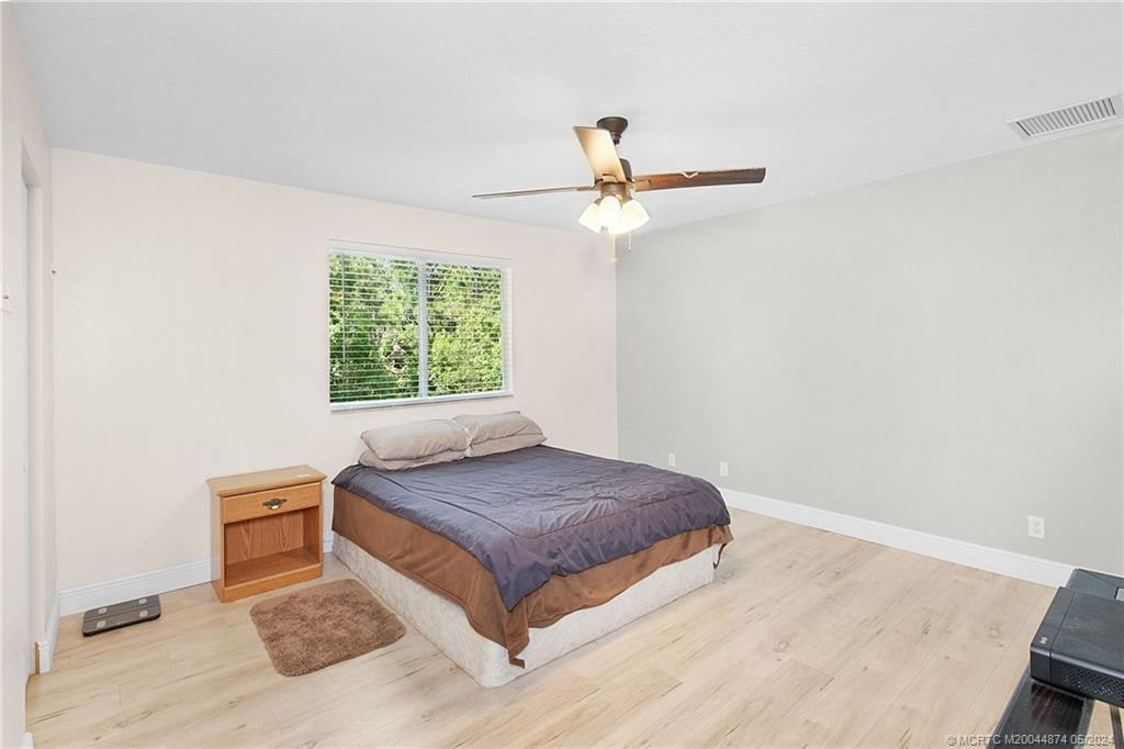 365 Southeast Bloxham Way Stuart, FL 34997 - Photo 12 of 27 a bedroom with a bed and a window