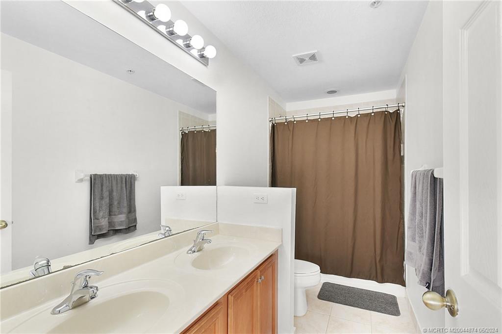365 Southeast Bloxham Way Stuart, FL 34997 - Photo 14 of 27 a bathroom with a sink and a mirror