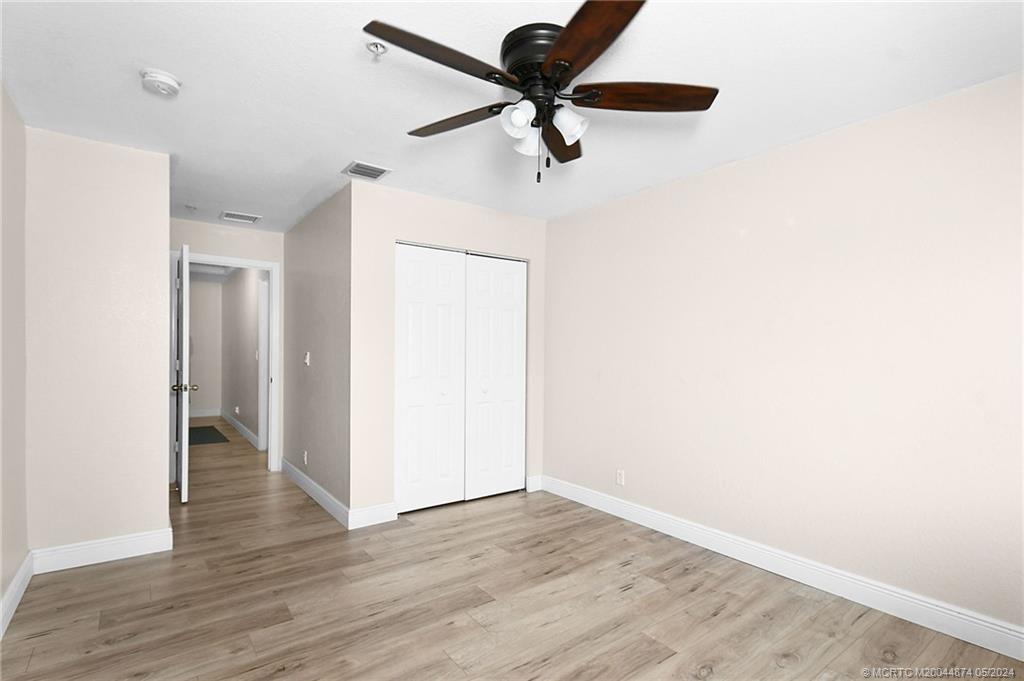 365 Southeast Bloxham Way Stuart, FL 34997 - Photo 16 of 27 a view of a room with wooden floor