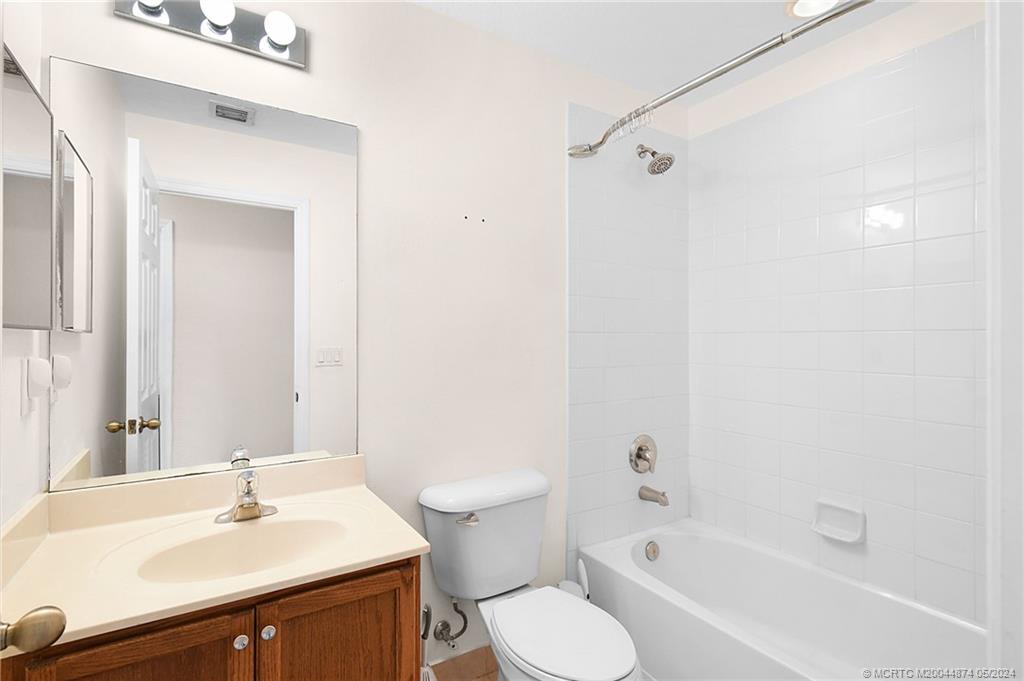 365 Southeast Bloxham Way Stuart, FL 34997 - Photo 19 of 27 a bathroom with a sink toilet and shower