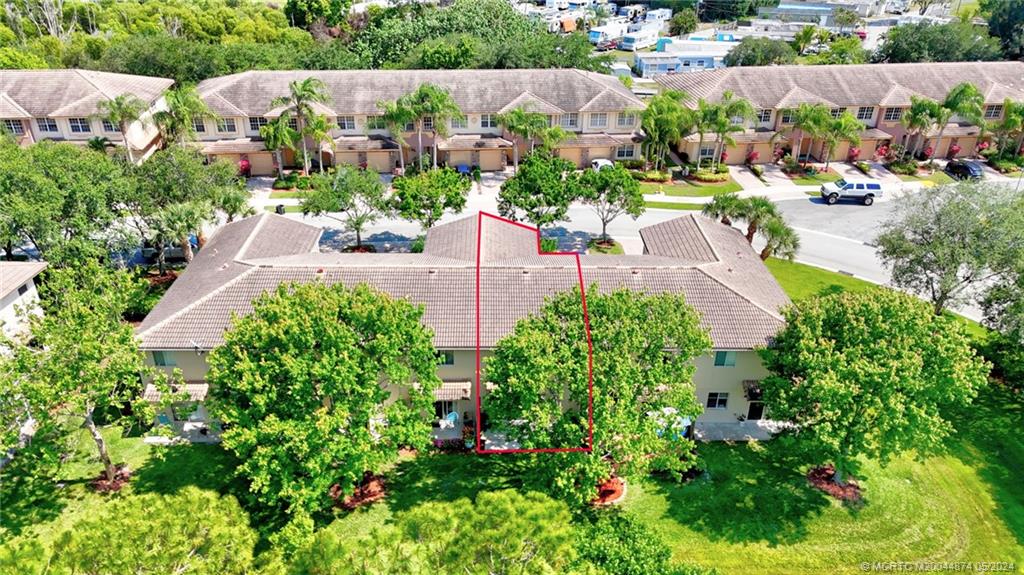 365 Southeast Bloxham Way Stuart, FL 34997 - Photo 27 of 27 an aerial view of a house with a yard and garden