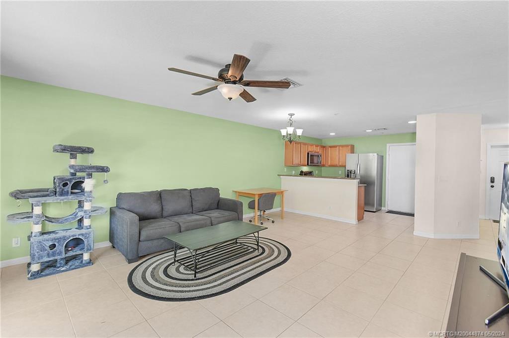 365 Southeast Bloxham Way Stuart, FL 34997 - Photo 5 of 27 a living room with furniture and a kitchen view