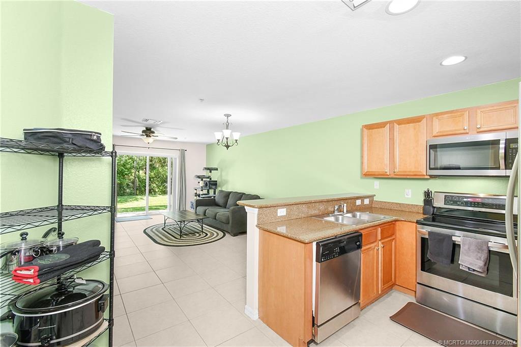 365 Southeast Bloxham Way Stuart, FL 34997 - Photo 7 of 27 a kitchen with a stove and a sink