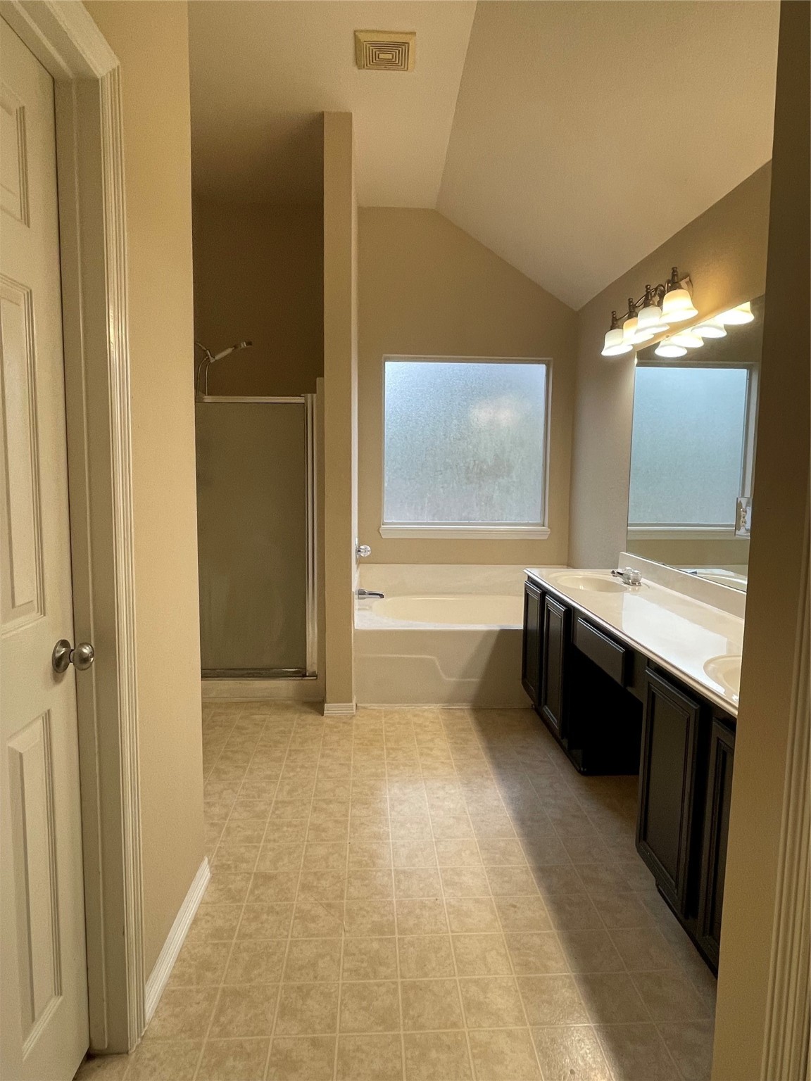 2223 Trey Rogillios Way Conroe, TX 77304 - Photo 9 of 10 a bathroom with a double vanity sink a mirror and a bathtub