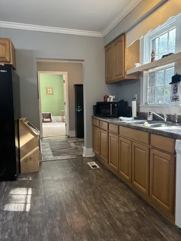 a kitchen with stainless steel appliances granite countertop a sink stove and cabinets