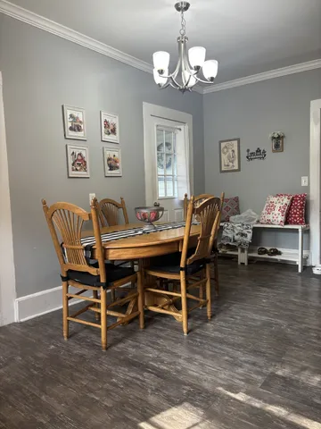 a dining room with furniture and chandelier