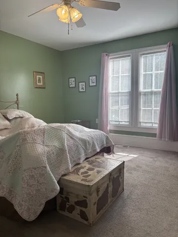 a bedroom with bed and window