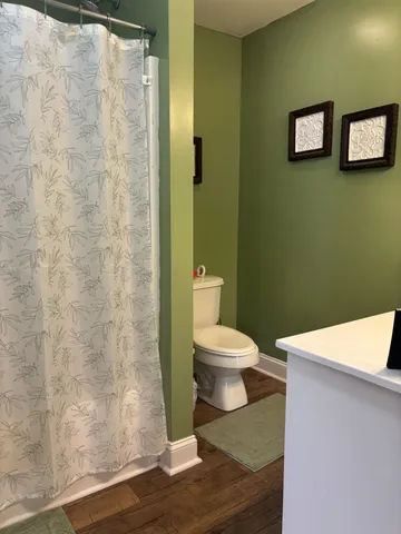 a white toilet sitting next to a bathroom sink