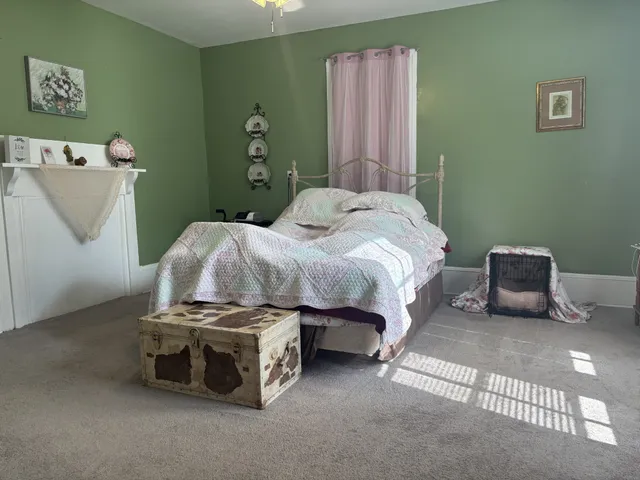 a bedroom with a bed and a couch