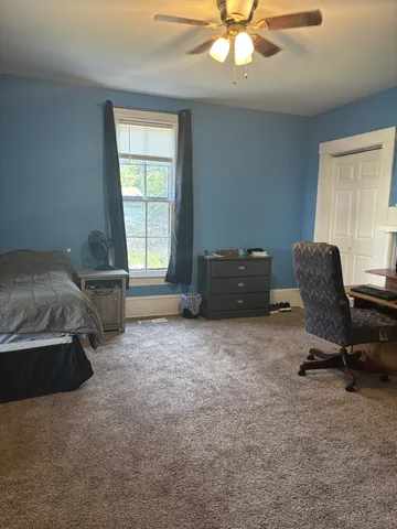 a bedroom with a bed and a chair