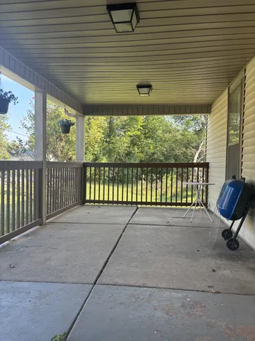 a view of a backyard with a large window and wooden fence