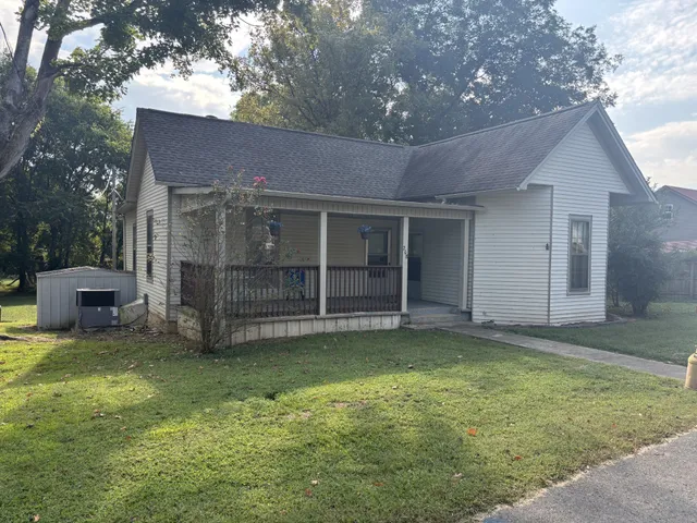 a view of a house with a garden and yard