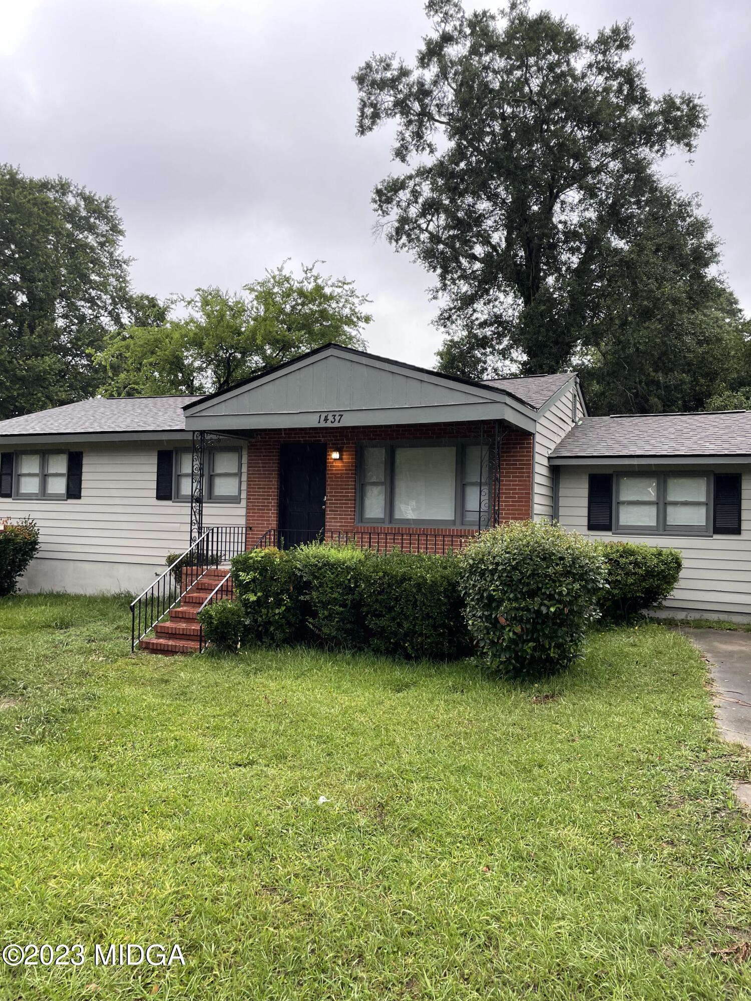 1437 Canterbury Road Macon, GA 31206 - Photo 1 of 18 a view of a house with a yard and plants