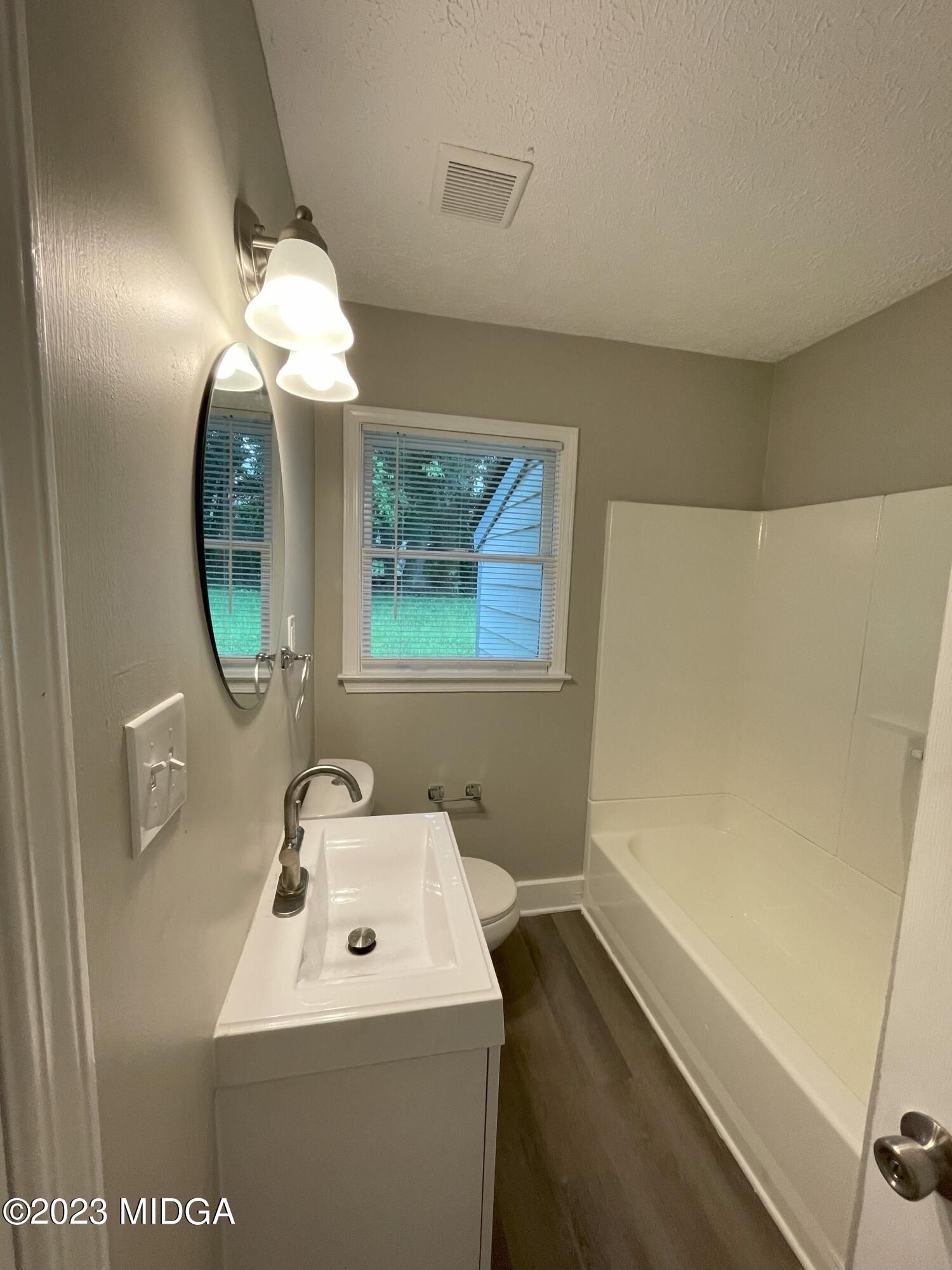 1437 Canterbury Road Macon, GA 31206 - Photo 11 of 18 a bathroom with a sink a light fixture and a mirror