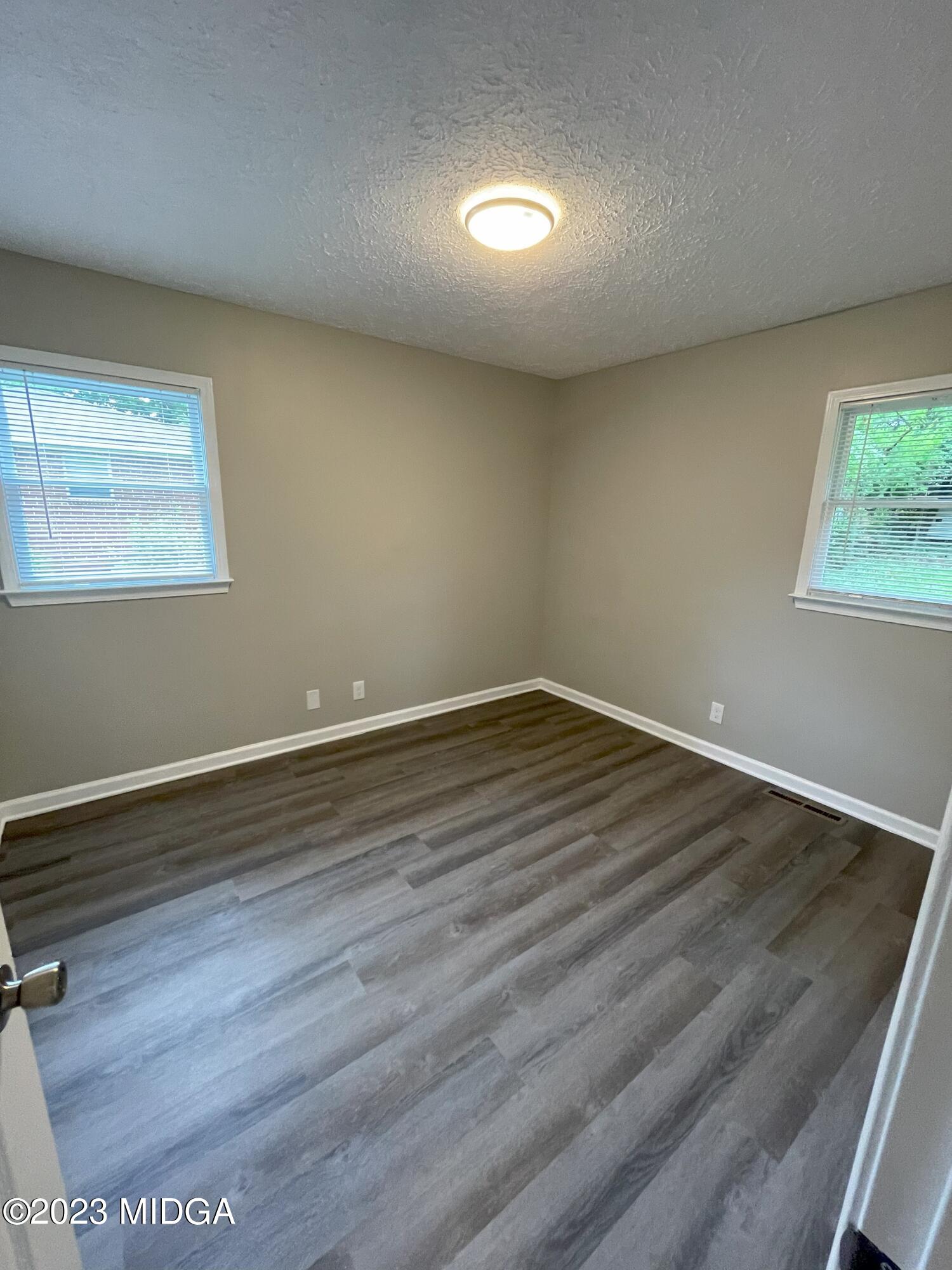 1437 Canterbury Road Macon, GA 31206 - Photo 12 of 18 a view of room with wooden floor and window