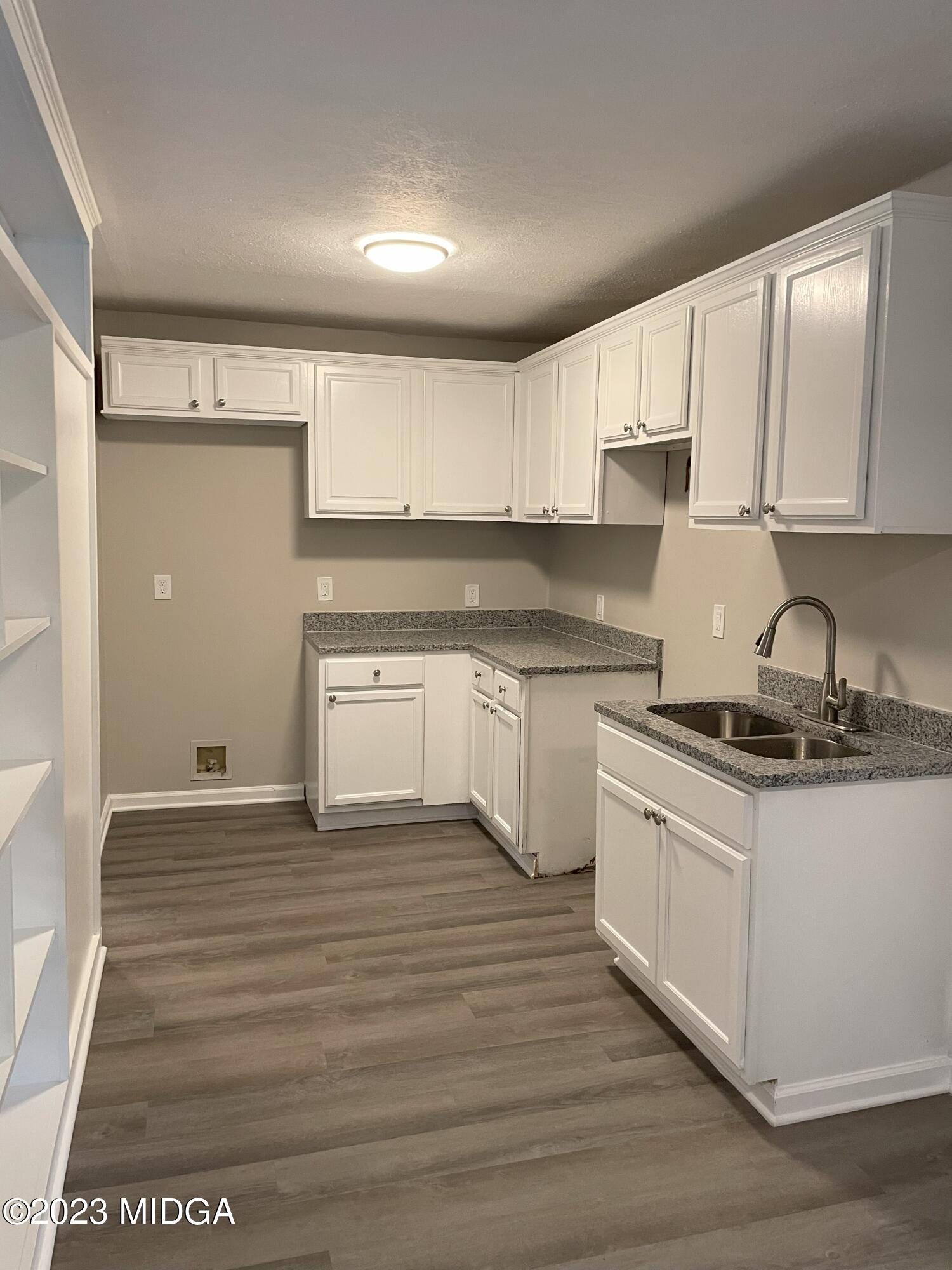 1437 Canterbury Road Macon, GA 31206 - Photo 7 of 18 a kitchen with stainless steel appliances granite countertop a stove a sink and white cabinets