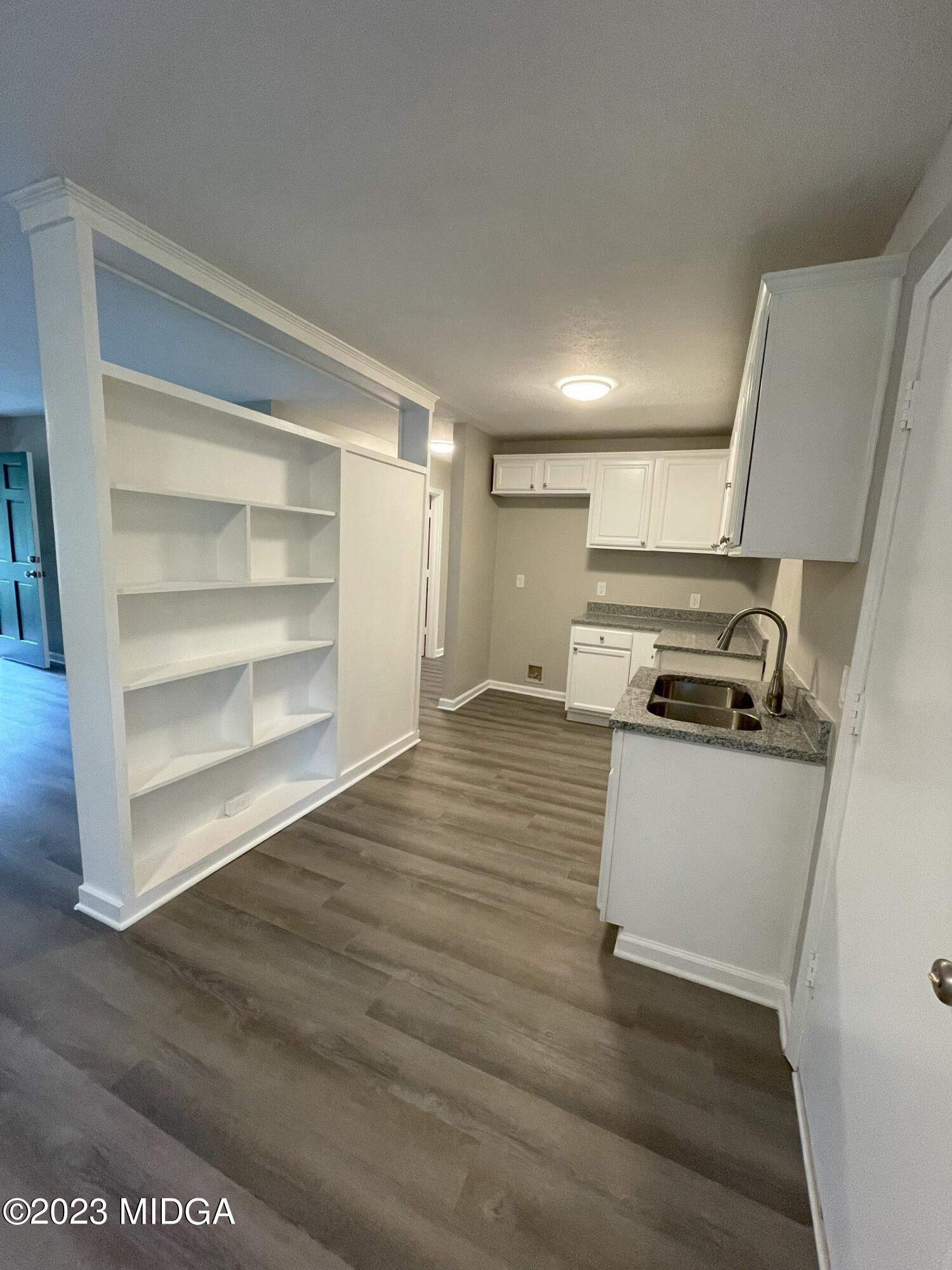 1437 Canterbury Road Macon, GA 31206 - Photo 8 of 18 a kitchen with wooden floors and a stove