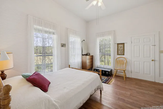 a room with a bed and wooden floor