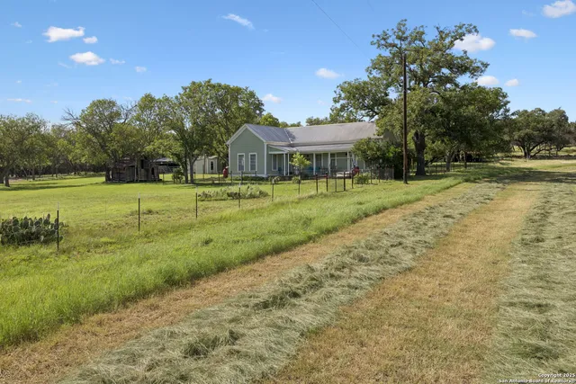 a front view of a house with a yard and outdoor seating