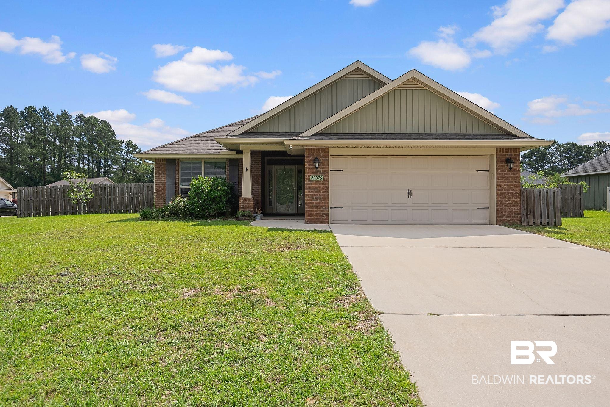 22076 Garland Loop Silverhill, AL 36576 - Photo 1 of 27 Single-story residence featuring a brick facade with light green siding and a covered entry