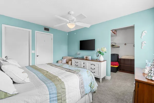 a bedroom with a bed and a flat screen tv