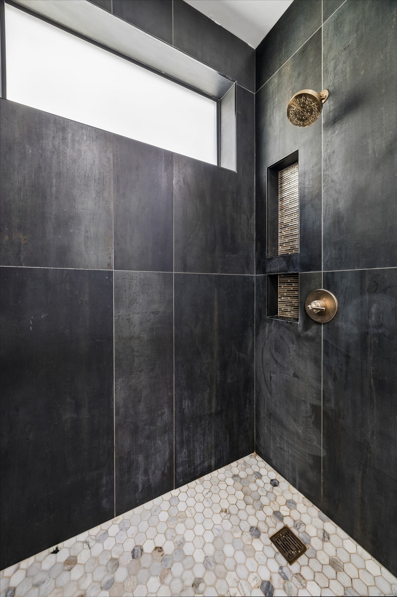 2014 Park Street Houston, TX 77019 - Photo 29 of 40 This beautifully updated shower is well lit with natural lighting. Niches for your accessories and a contrasting marble floor.