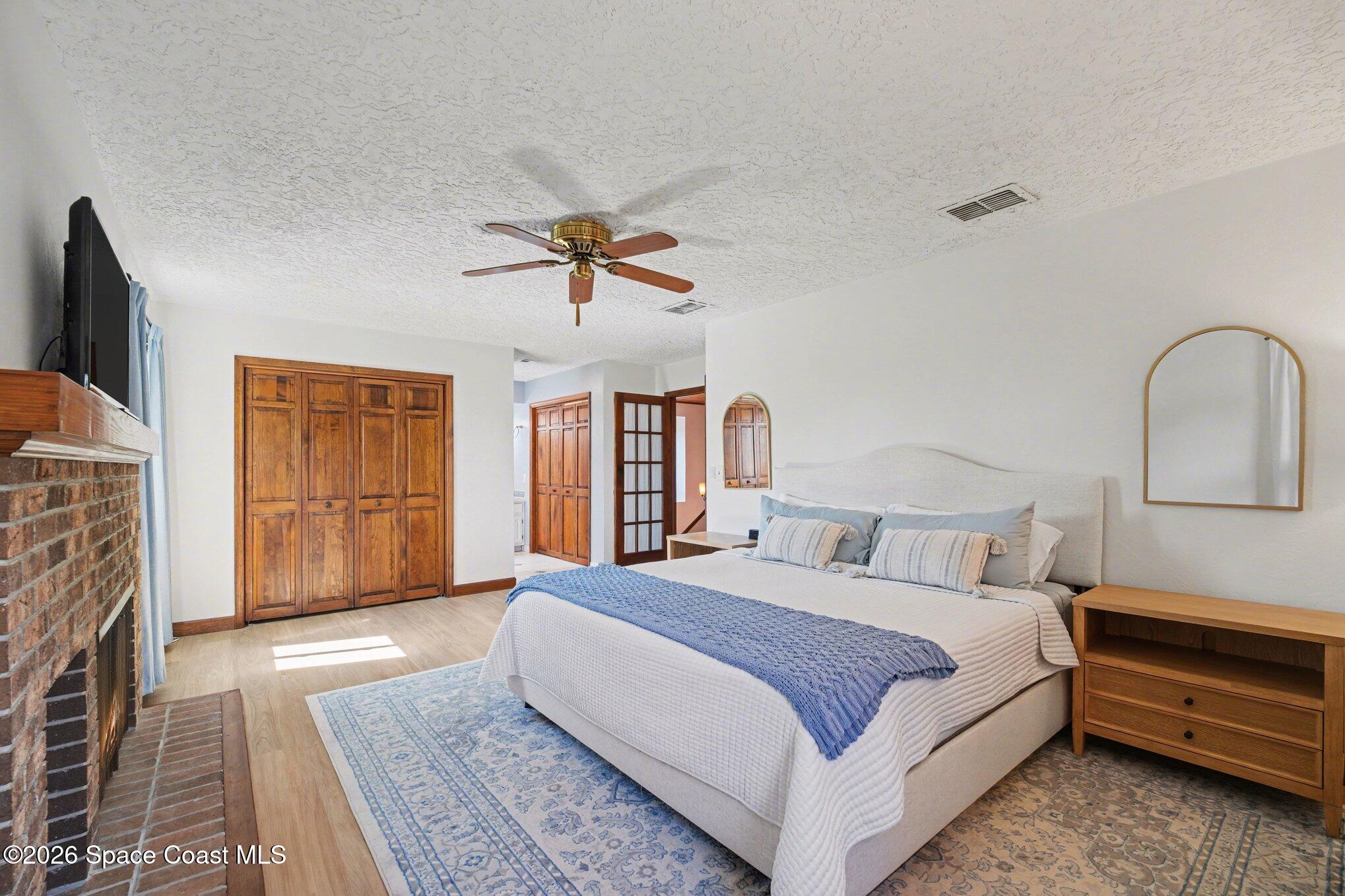 568 Rio Casa Drive North Indialantic, FL 32903 - Photo 12 of 45 a bedroom with a large bed and a chandelier