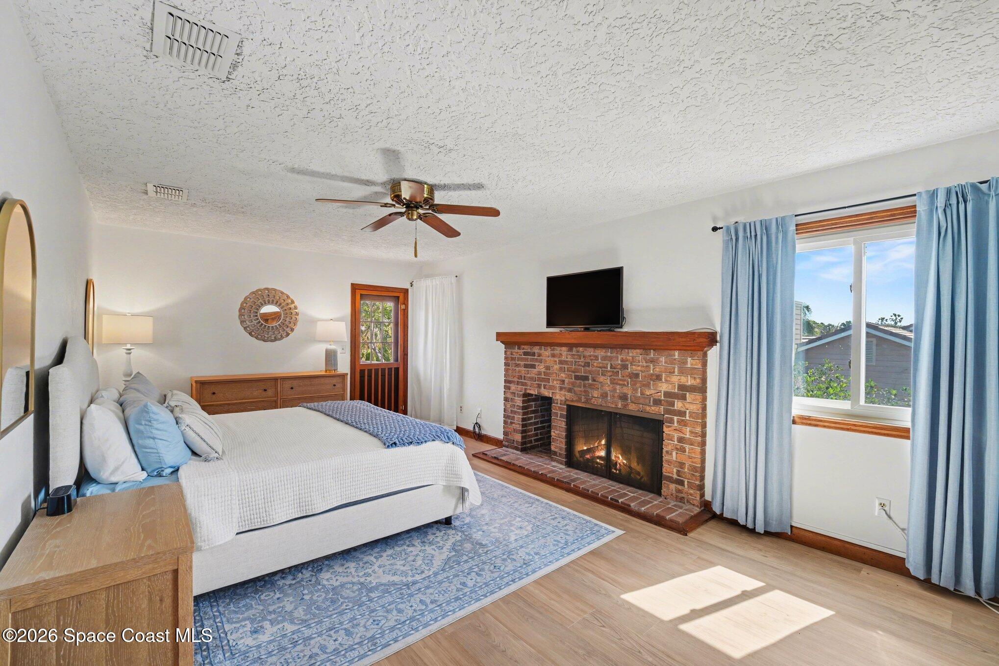 568 Rio Casa Drive North Indialantic, FL 32903 - Photo 13 of 45 a bedroom with a bed and a fireplace