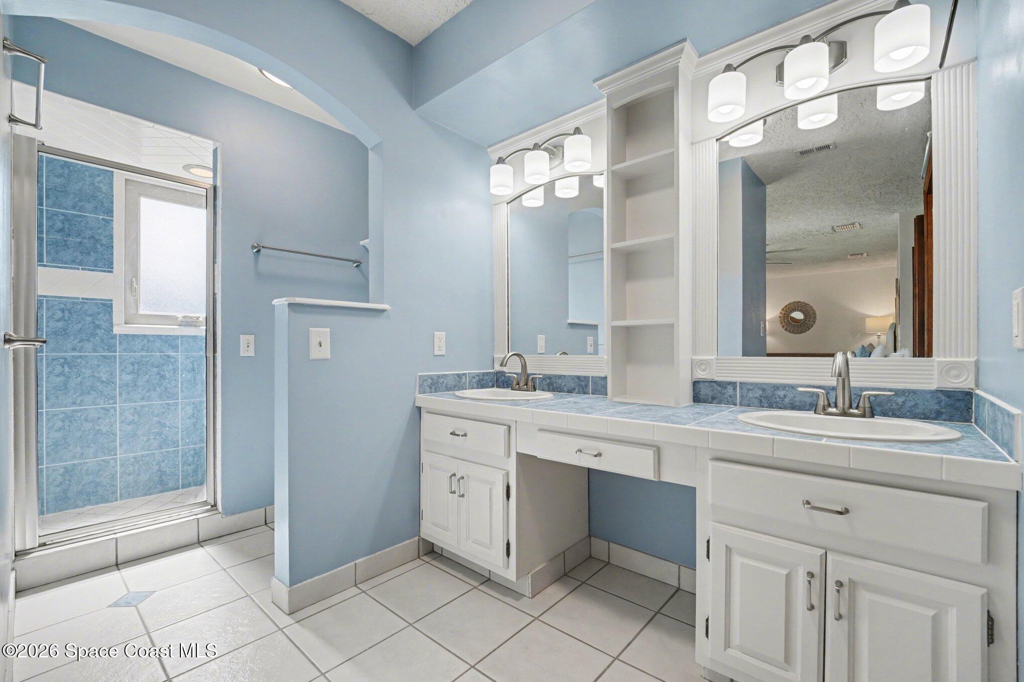 568 Rio Casa Drive North Indialantic, FL 32903 - Photo 15 of 45 a spacious bathroom with a granite countertop sink mirror and double