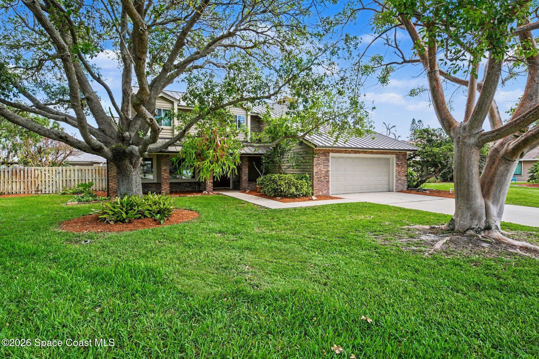 568 Rio Casa Drive North Indialantic, FL 32903 - Photo 2 of 45 a view of a house with backyard and a tree