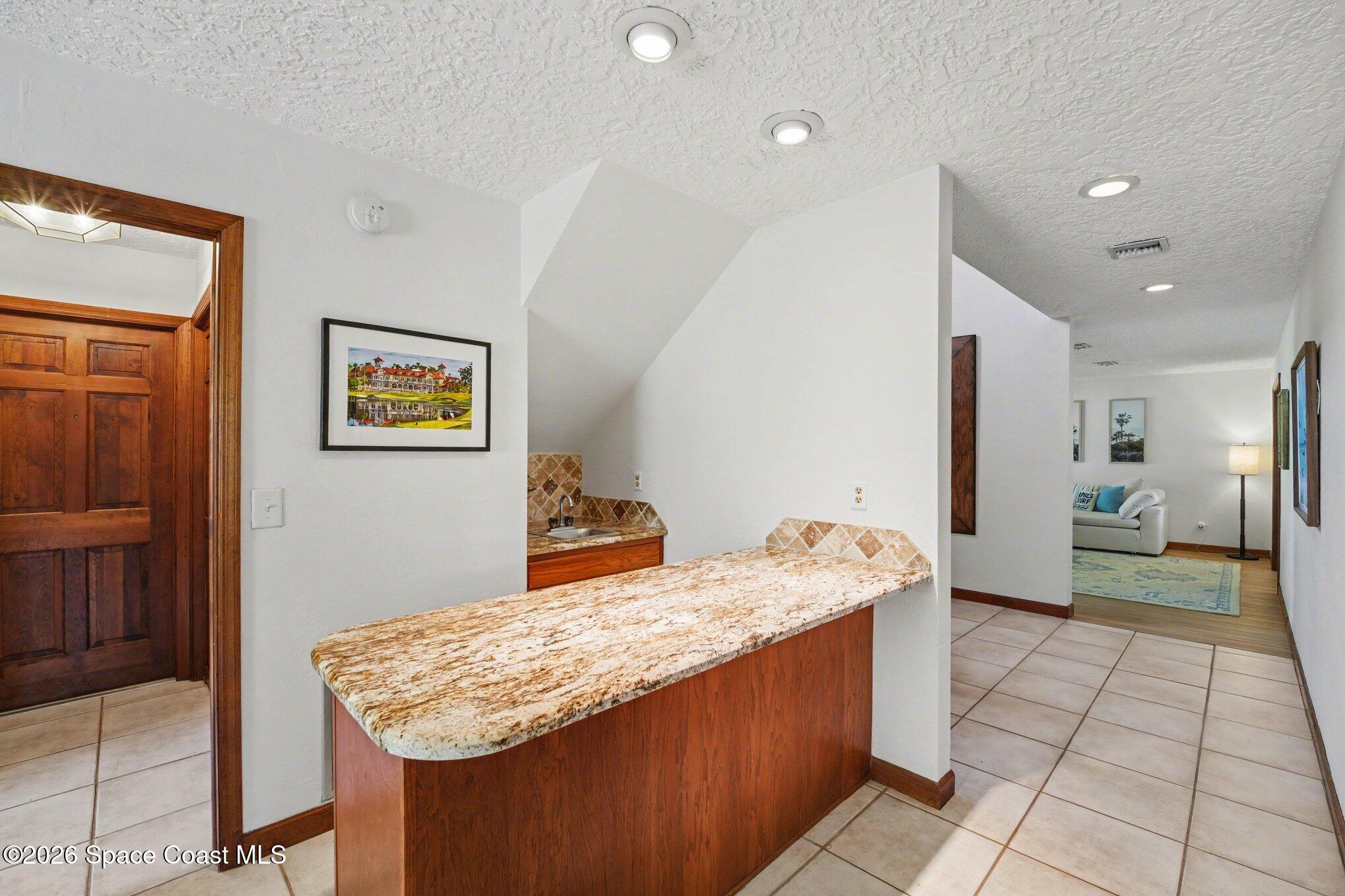568 Rio Casa Drive North Indialantic, FL 32903 - Photo 24 of 45 a kitchen with stainless steel appliances granite countertop a sink stove and refrigerator
