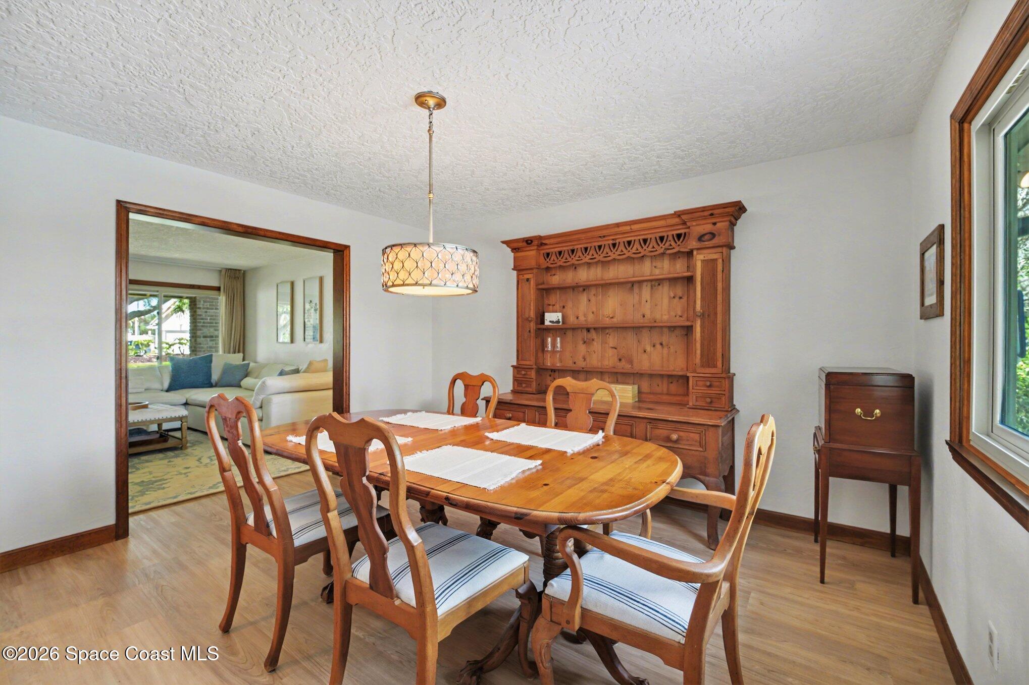 568 Rio Casa Drive North Indialantic, FL 32903 - Photo 25 of 45 a view of a dining room with furniture window and wooden floor