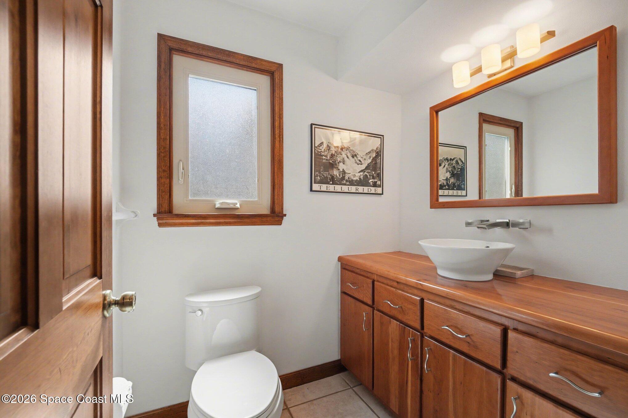 568 Rio Casa Drive North Indialantic, FL 32903 - Photo 28 of 45 a bathroom with a toilet sink and mirror