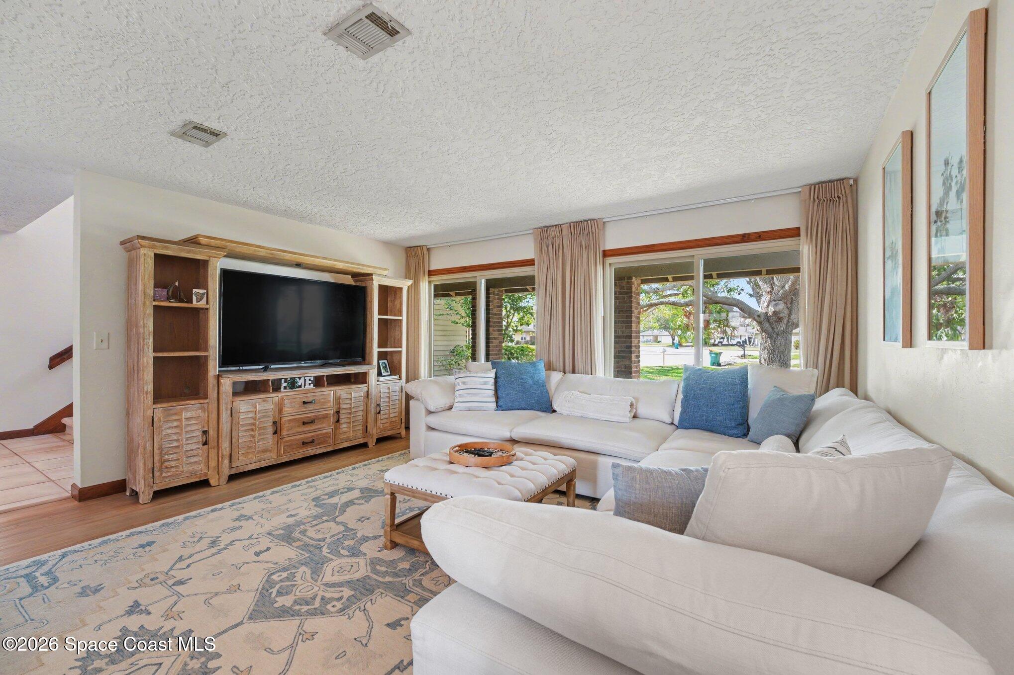 568 Rio Casa Drive North Indialantic, FL 32903 - Photo 6 of 45 a living room with furniture and a flat screen tv