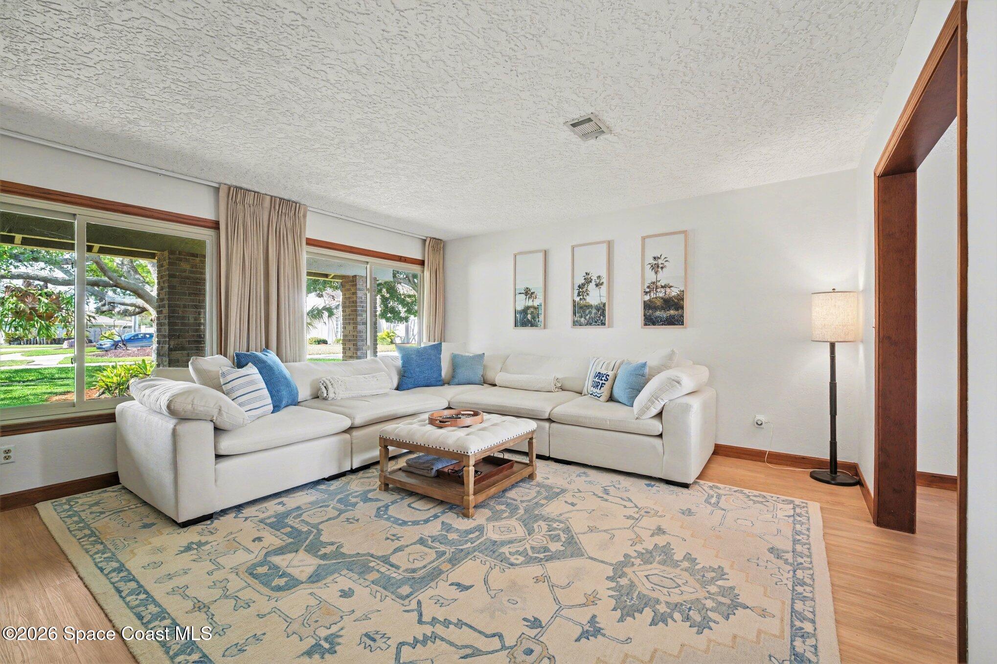 568 Rio Casa Drive North Indialantic, FL 32903 - Photo 7 of 45 a living room with furniture and a large window