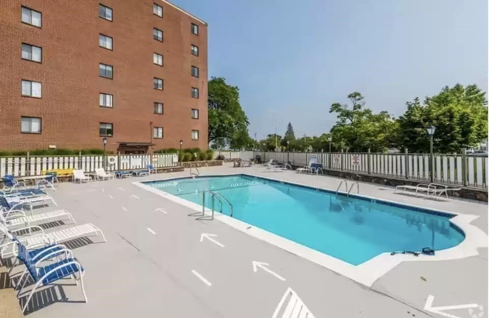 2 Ocean, Unit 402 Revere, MA 02151 - Photo 15 of 16 a view of a swimming pool with a lounge chairs