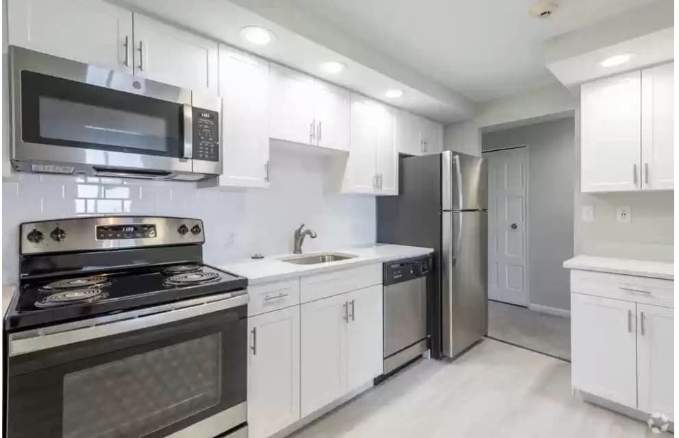 2 Ocean, Unit 402 Revere, MA 02151 - Photo 3 of 16 a kitchen with stainless steel appliances a stove a sink and a microwave
